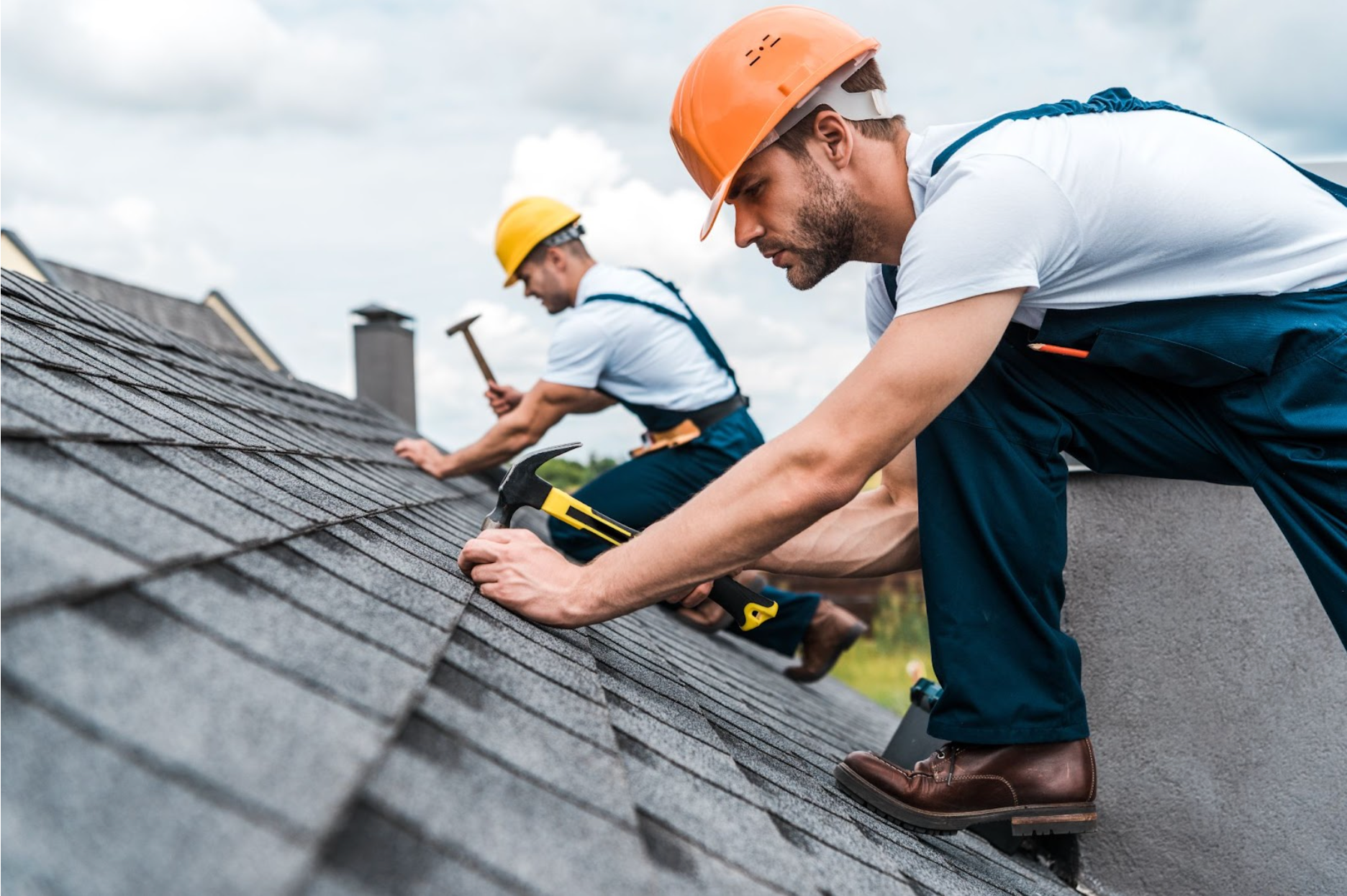Professional roofing crew installing shingles on a modern home